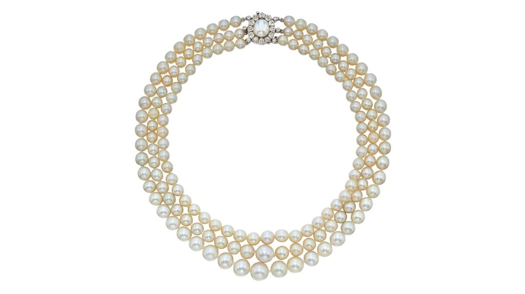 A necklace of graduated natural and cultured pearls with a clasp made of a semi-baroque pearl framed by diamonds three-strand pearl necklace Mary Ethel Weinmann